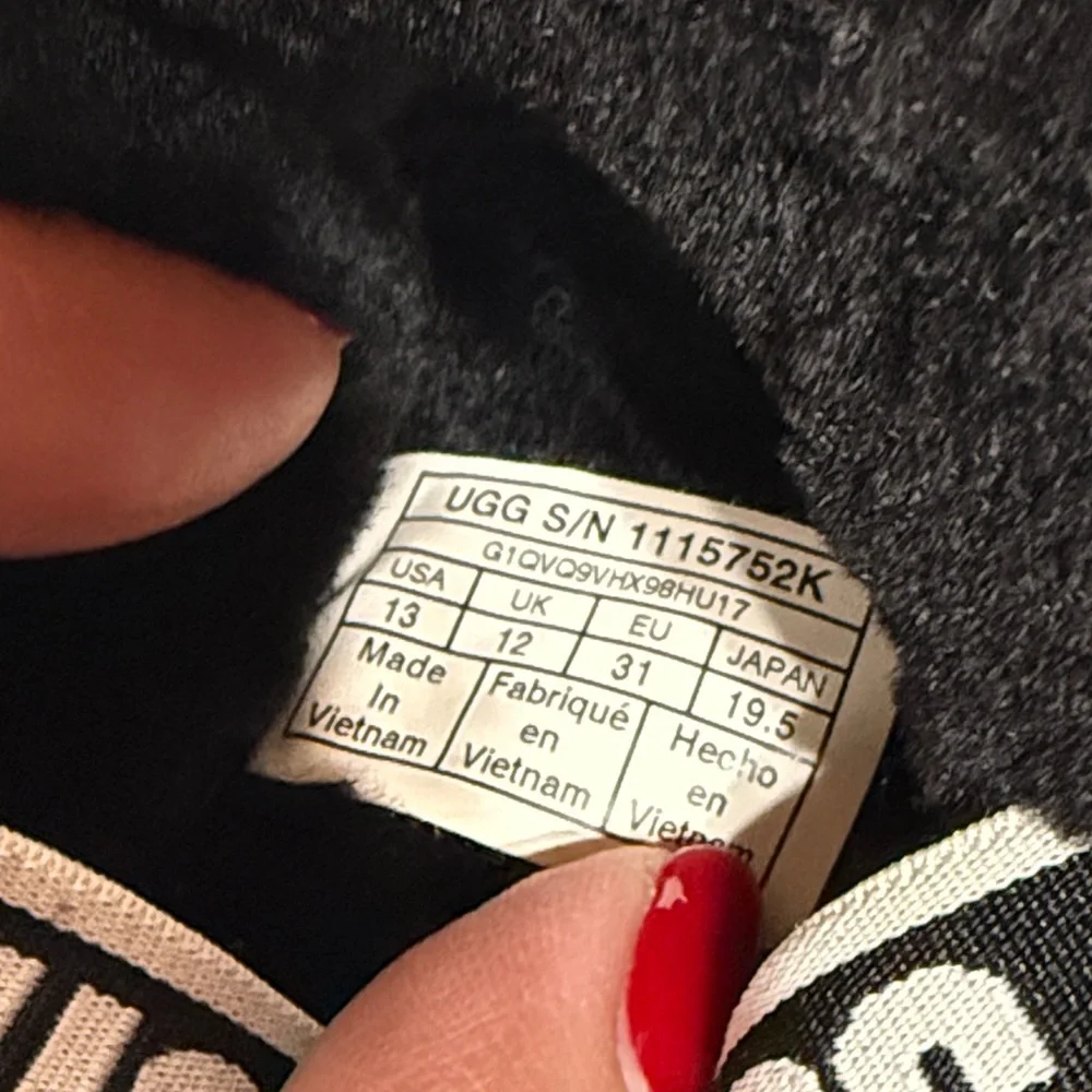 UGG “Oh Yeah” Slide Sandals in Black Sheepskin with an Elastic UGG Logo Strap
